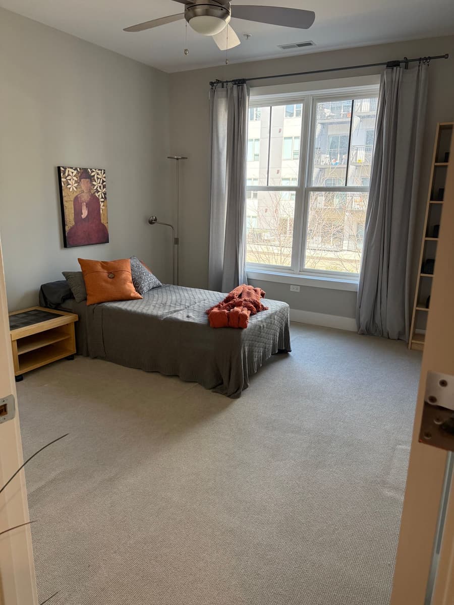 Furnished bedroom with natural light after standard house cleaning