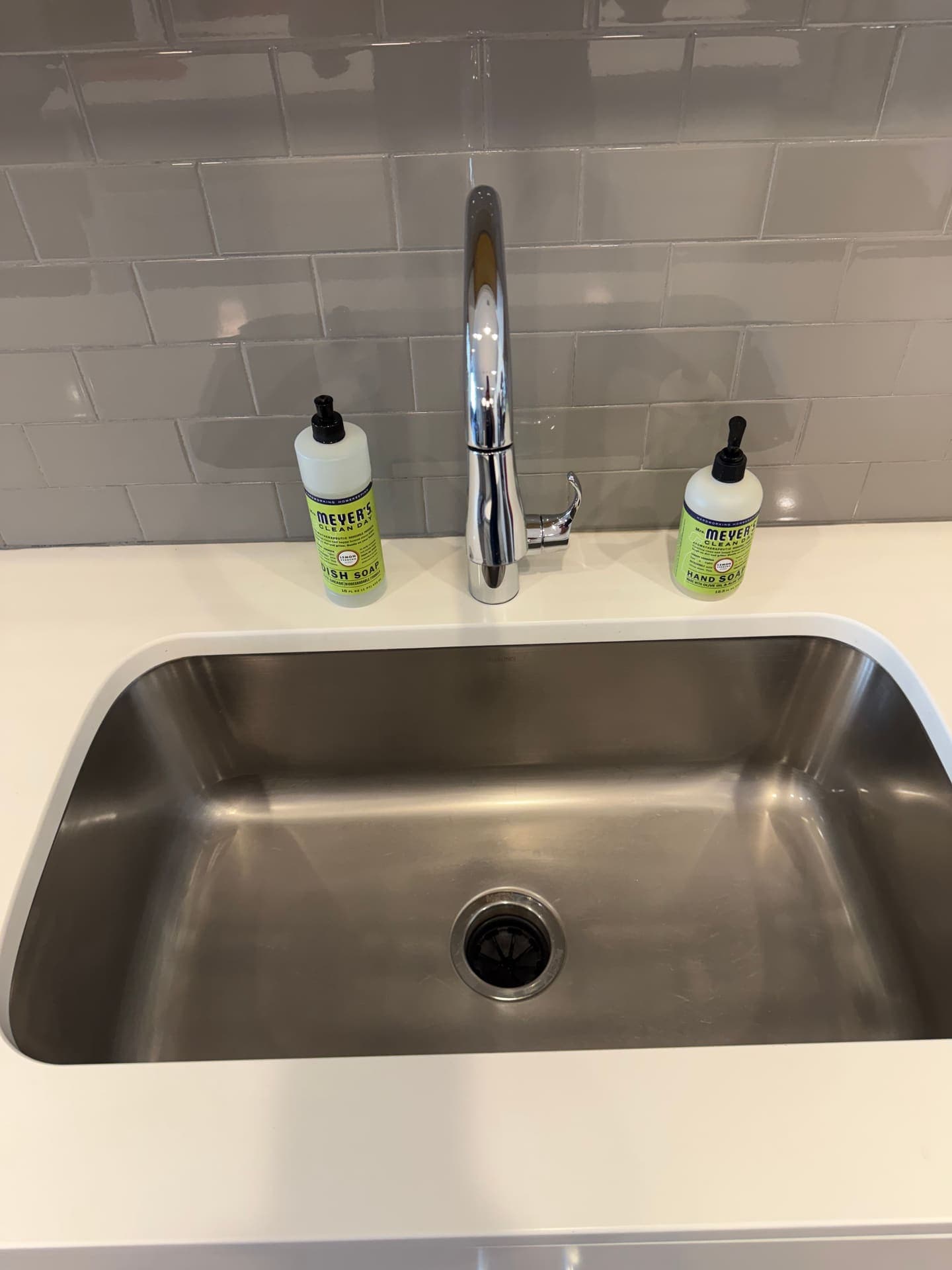Polished faucet and spotless stainless sink basin after a DSM Cleaning Solutions deep clean